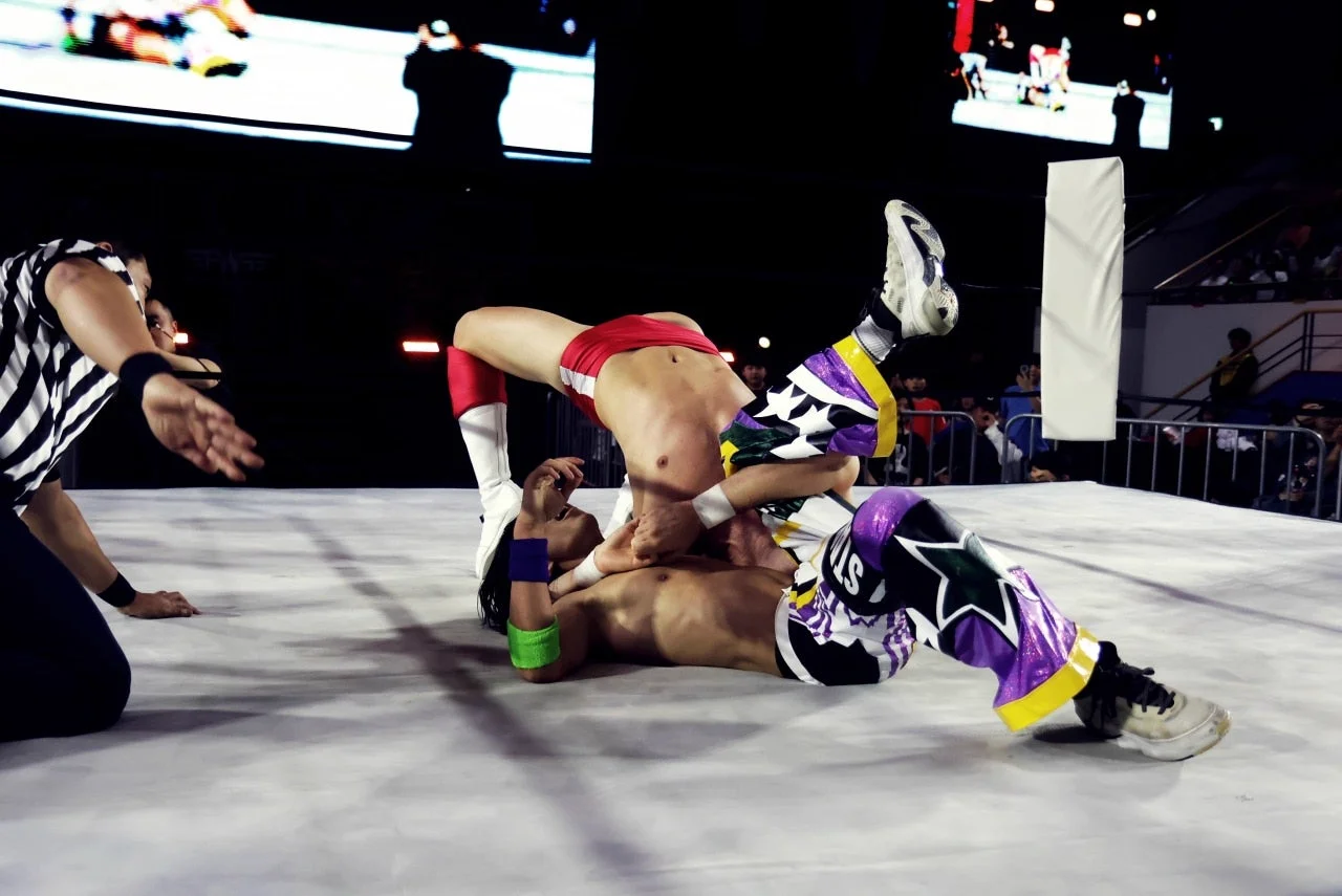 Handsome Jay hitting the Handsome Plex suplex mid-move in the ring
